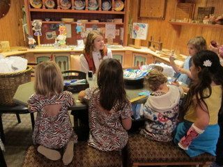 Children interacting with a cast member at the Norway Kidcot Fun Stop.