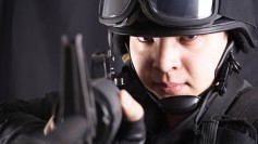 Militarized police, aiming at viewer