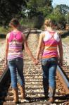 Two girls on a train track
