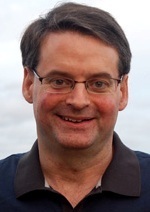 Caucasian Male with glasses, smiling