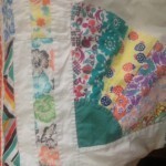 Closeup of the Pilly quilt and binding (which she made from a pillowcase, clever girl)