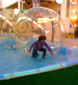 Wambui in giant plastic ball in water