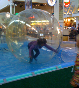 Wambui in a giabt plastic ball in the water