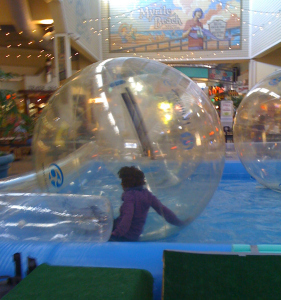 Wambui in a giant ball in the water