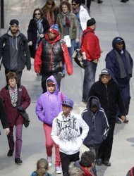 In this photo taken March 13, 2013, pedestrians walk in New York's Times Square. An historic decline in the number of U.S. whites and the fast growth of Latinos are blurring traditional black-white color lines in the U.S. The demographic shift is now a potent backdrop to an immigration overhaul bill, being debated in Congress, that could offer a path to citizenship for 11 million mostly Hispanic illegal immigrants. (AP Photo/Seth Wenig)