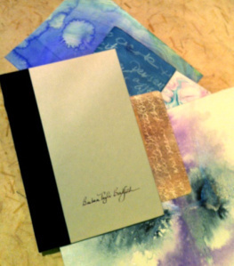 Surface decorated papers that will be re-worked into the cover of this recycled book.