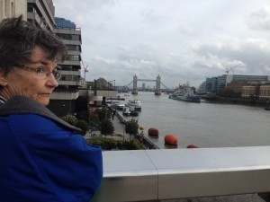 my mom stands on london bridge, across from tower bridge.