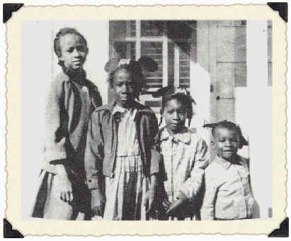 Wambui and siblings with micky mouse ears