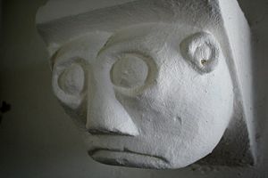 English: Glum face Corbel in St.Benedict's chu...