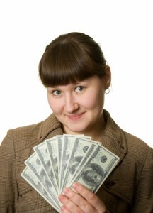 A woman with money that symbolizes the phrase that pays