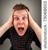stock photo : Portrait of screaming surprised man holding head