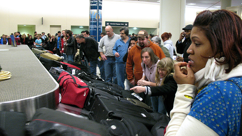 Passengers at an airport in Chicago look at a carousel with baggage from 25 delayed flights.