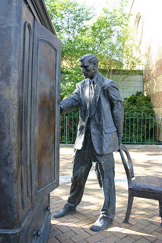 Statue of C.S. Lewis looking into a wardrobe. Entitled 
