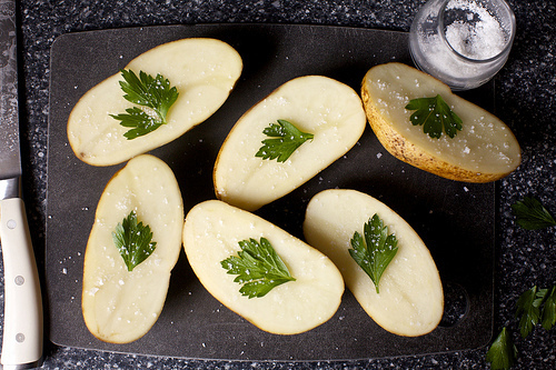 one leaf per potato half, plus salt