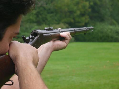 The Remington rolling-block rifle, with its breech open.