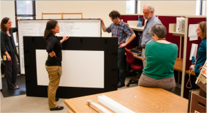 Conservation Division and Manuscript Division staff review white board placed in completed protective housing. / Photo by Richard Hebert