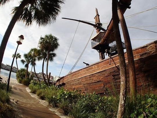 You enter the slide access area behind the shipwreck, near the beach.