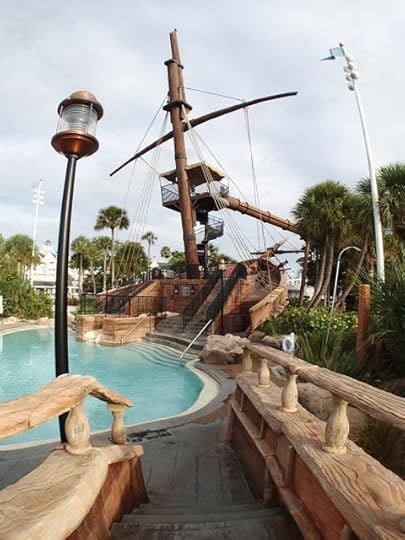 You access the slides from the rear of the shipwreck, near the beach. The spiral staircase along the mast gets to to the main slide. The junior slide is below.