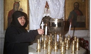 (FILES) A Syrian nun lights candles insi