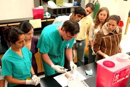 Medical students learning about stitches
