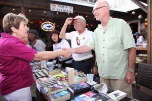 Sandy Balzo, left, Jerry Healy and Rod Philbrick meet Cathy Keller, owner of Hooked on Books in Islamorada.