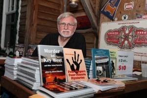 Sherril Rhoades with a few of the books he publishes.
