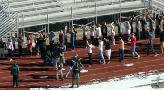 Students from Arapahoe High School evacuate their building in Centennial