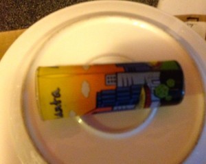 Picture of a shot glass glued on the back of a plate