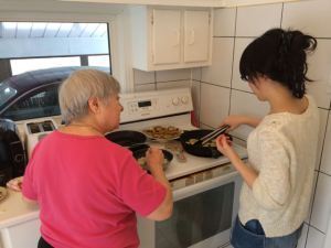 Akemi and mom work on the fried eggplant