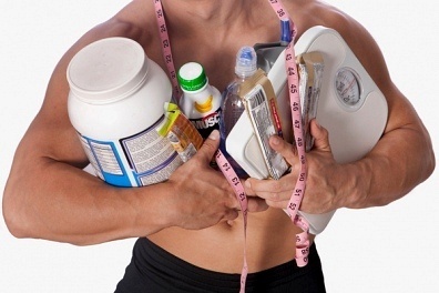 Man with a lot of bodybuilding supplements.