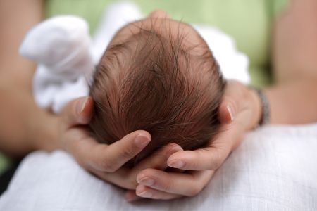 In his mother's hands