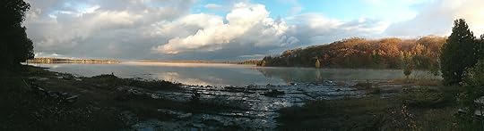 A photograph of a lakeshore in autumn