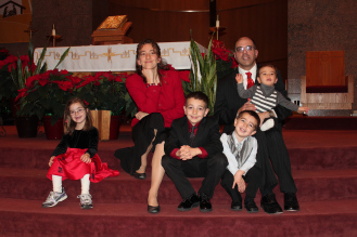 The annual family Christmas shot, taken after Mass. Another one of those pictures that tells you everything you need to know about our family at this point in time: Miss Independent off on her own, Nicholas being cheesy, and Michael trying his utmost to get free. :)