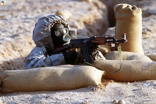 English: A Syrian soldier aims an AK-47 assaul...