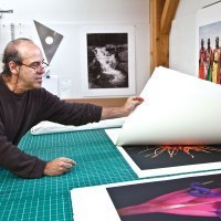 Jon Cone flips through his large scale prints.