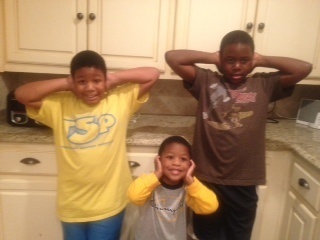 children with hands over ears