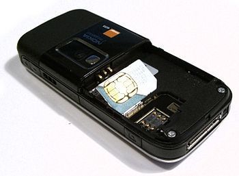 English: A mini SIM card next to its electrica...