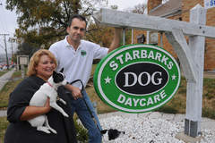 AndreMcCarthy-Grzybek holding Boo her husbAl Grzybek run daycare boarding center for dogs called Starbarks. Starbucks Coffee says their logo one