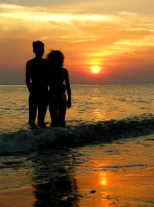 couple on beach. sunrise.