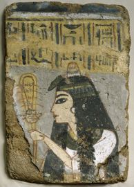 A priestess shakes the sistrum to please the Goddess