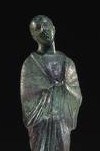 A priest of Isis carries a sacred vessel in veiled hands