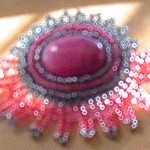Image of a pink beaded brooch created by speculative fiction writer Ann Leckie, to illustrate piece about her book, Ancillary Justice, for a piece on www.kittywumpus.net