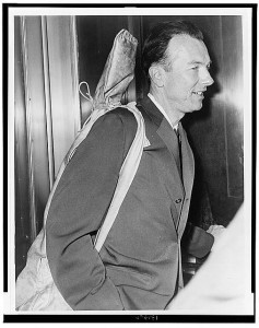Pete Seeger arrives at Federal Court with his guitar over his shoulder, April 1961. World Telegram photo by Walter Albertin. 
