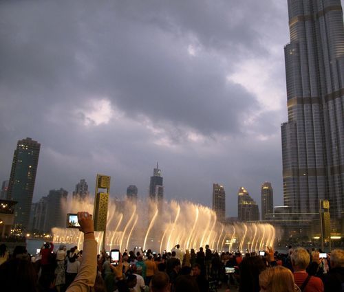 Clouds swirl above the dancing fountain at the Mall of Dubai.