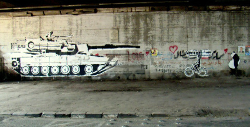 Ganzeer tank versus bike work, under the October 6th Bridge. Copyright Suzee in the City.