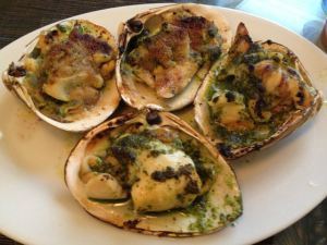 Roasted clams with garlic, parsley, and olive oil.