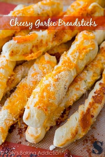 Soft and fluffy garlic infused breadsticks covered in melted cheese. Step-by-step visuals to help guide you included! Recipe at sallysbakingaddiction.com