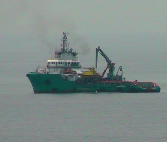 A SUPPLY VESSEL FROM SHORE APPROACHES THE RIG. AMAZINGLY, FISHERMEN FROM COASTAL COMMUNITIES VENTURE OUT THIS FAR IN THEIR CANOES, AND FATAL COLLISIONS WITH SUPPLY VESSELS HAVE OCCURRED. AS IS EVIDENT IN MURDER AT CAPE THREE POINTS, RIG CREWS ARE NOT SANGUINE ABOUT THE FISHERMEN'S PRESENCE