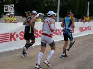 …Like this guy (on the right), who ran past as I was waiting for my wife to exit T2 at the 2011 Ironman Louisville. 