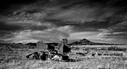 Derelict Car & Building Under a Stormy Sky